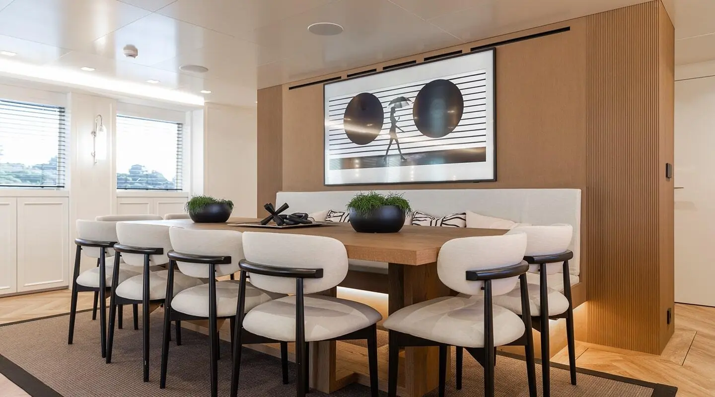 Illusion II yacht interior dining area with wooden table and chairs