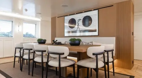 Illusion II yacht interior dining area with wooden table and chairs