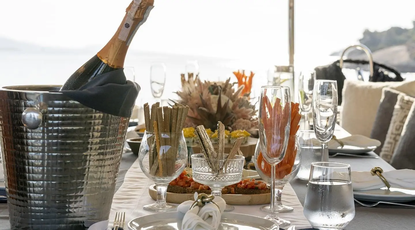 Gozdem The One yacht table set with wine glasses during sunset on deck