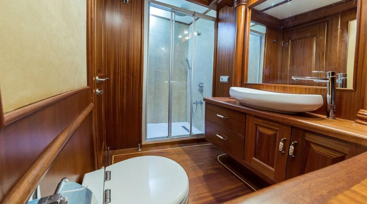 Wood-paneled bathroom with shower enclosure and a vessel sink