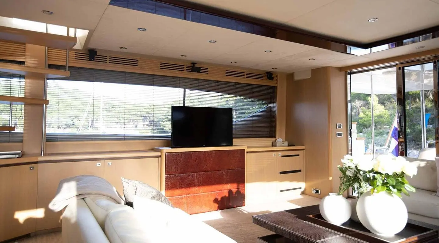 Insieme luxury yacht interior salon with beige wood cabinetry and TV centerpiece