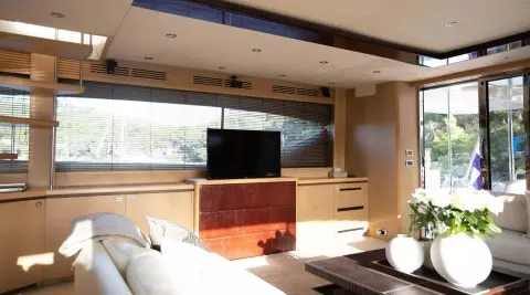 Insieme luxury yacht interior salon with beige wood cabinetry and TV centerpiece