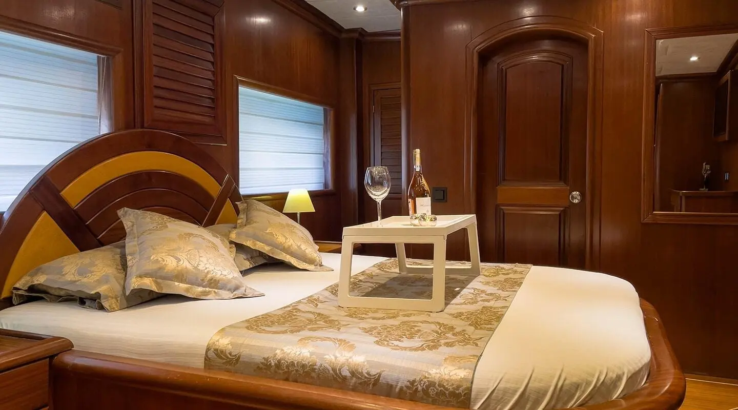 Diva Deniz luxury gulet at sunset with deck seating and warm wood interiors