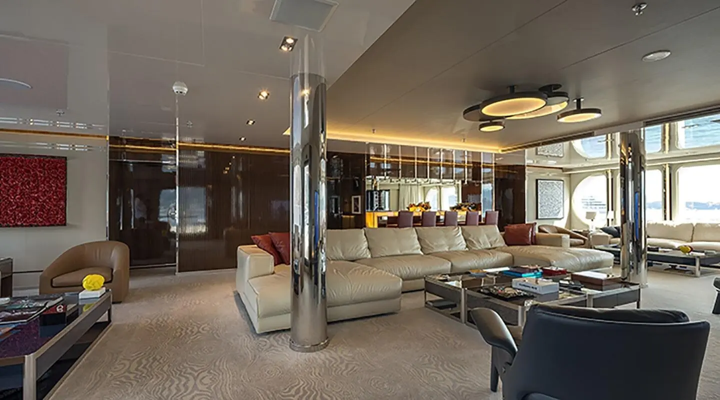 Marquise yacht lounge on deck with seating, glass walls, and warm lighting