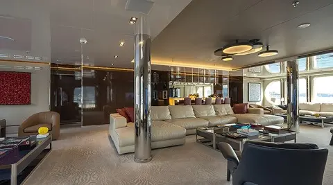 Marquise yacht lounge on deck with seating, glass walls, and warm lighting