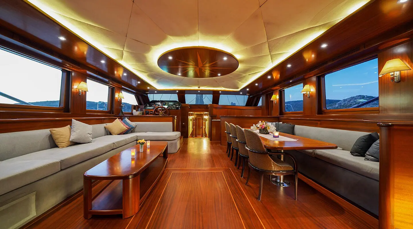 Interior of La Bella Vita luxury gulet at sunset with polished wooden deck