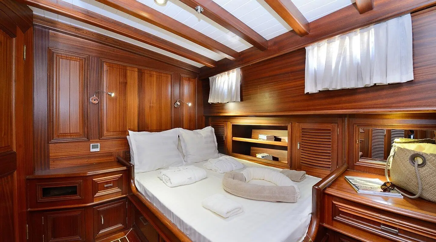 Samarkand yacht interior cabin with two single beds and wooden panels