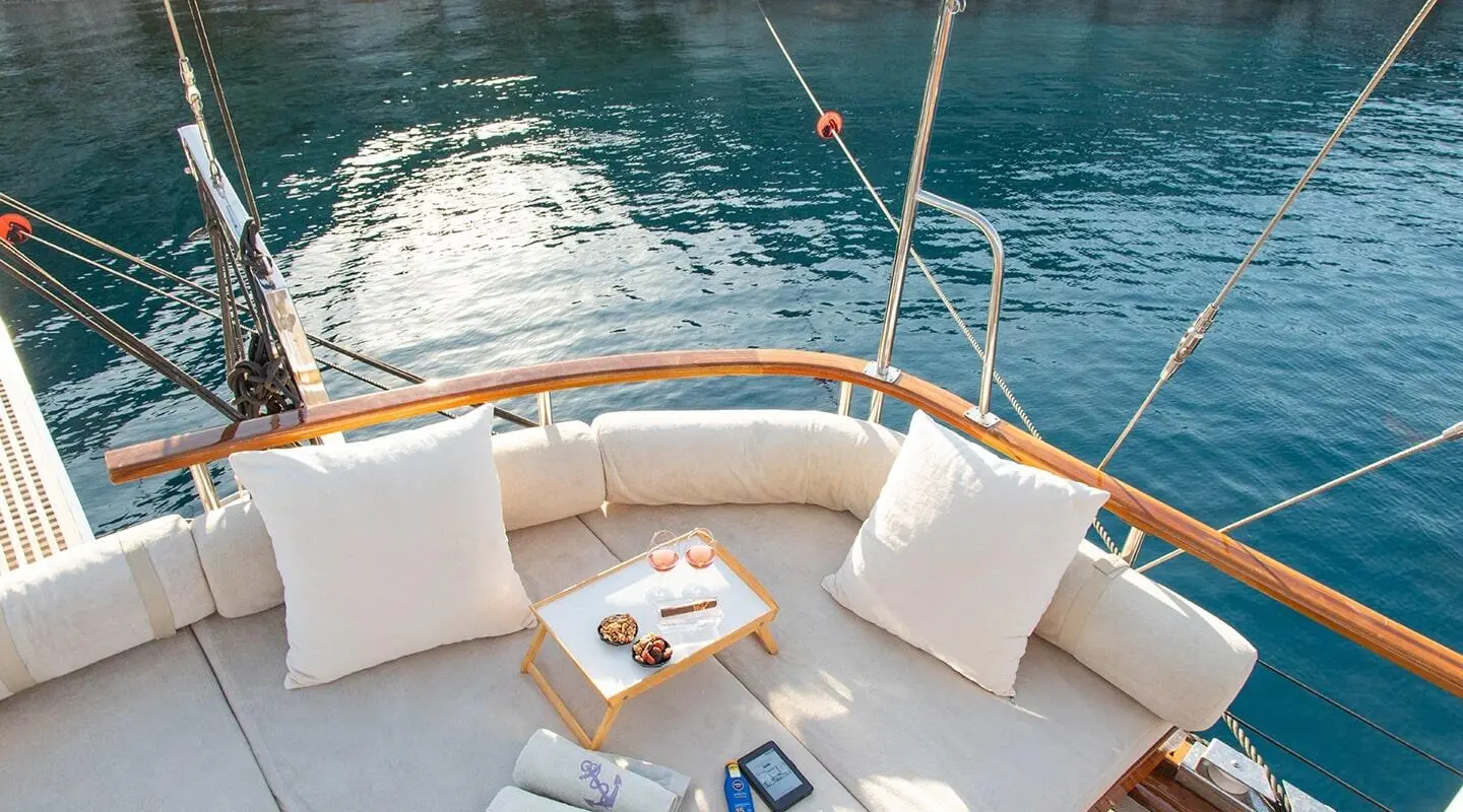 Derin Deniz yacht deck seating with cushions overlooking turquoise sea at sunset