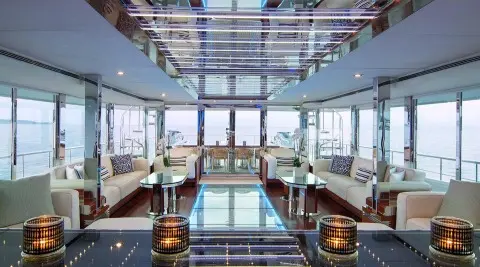 Interior of O'Natalina motor yacht saloon with polished wooden floor and seating
