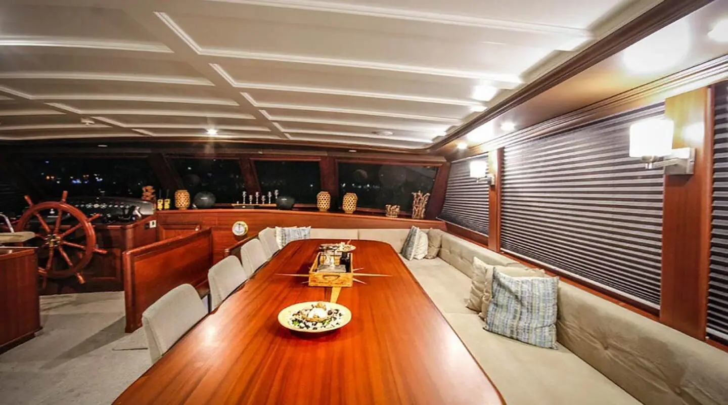 Luxurious yacht Virtuoso exterior deck at sunset with polished wood and seating