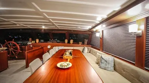 Luxurious yacht Virtuoso exterior deck at sunset with polished wood and seating