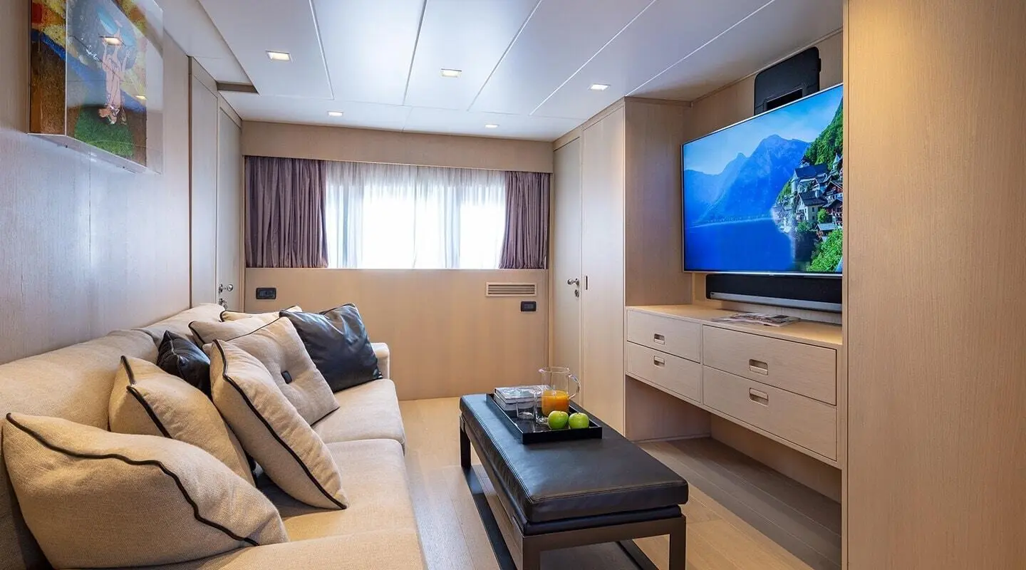 Yacht interior on Summer Fun with beige sofa, coffee table, and TV screen