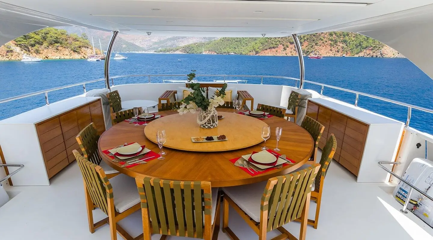 Takara One yacht deck dining table set for guests with sunset ocean view