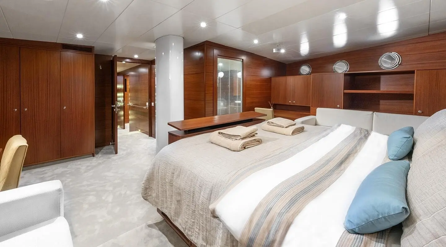 Master cabin on Lucky You gulet with two beds and wood-panel walls