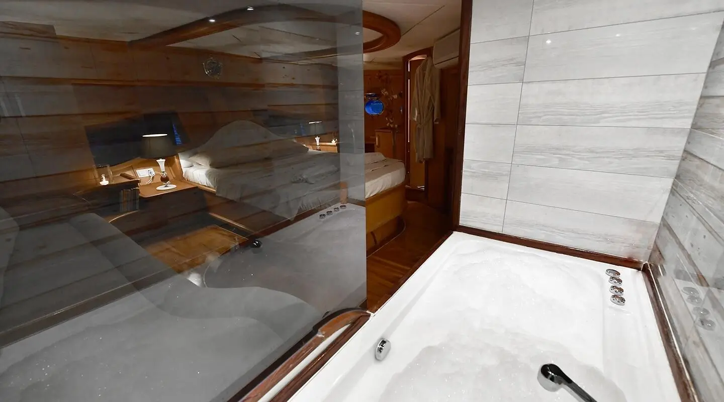 Blu Dream yacht interior and deck at sunset, glass door open to cabin