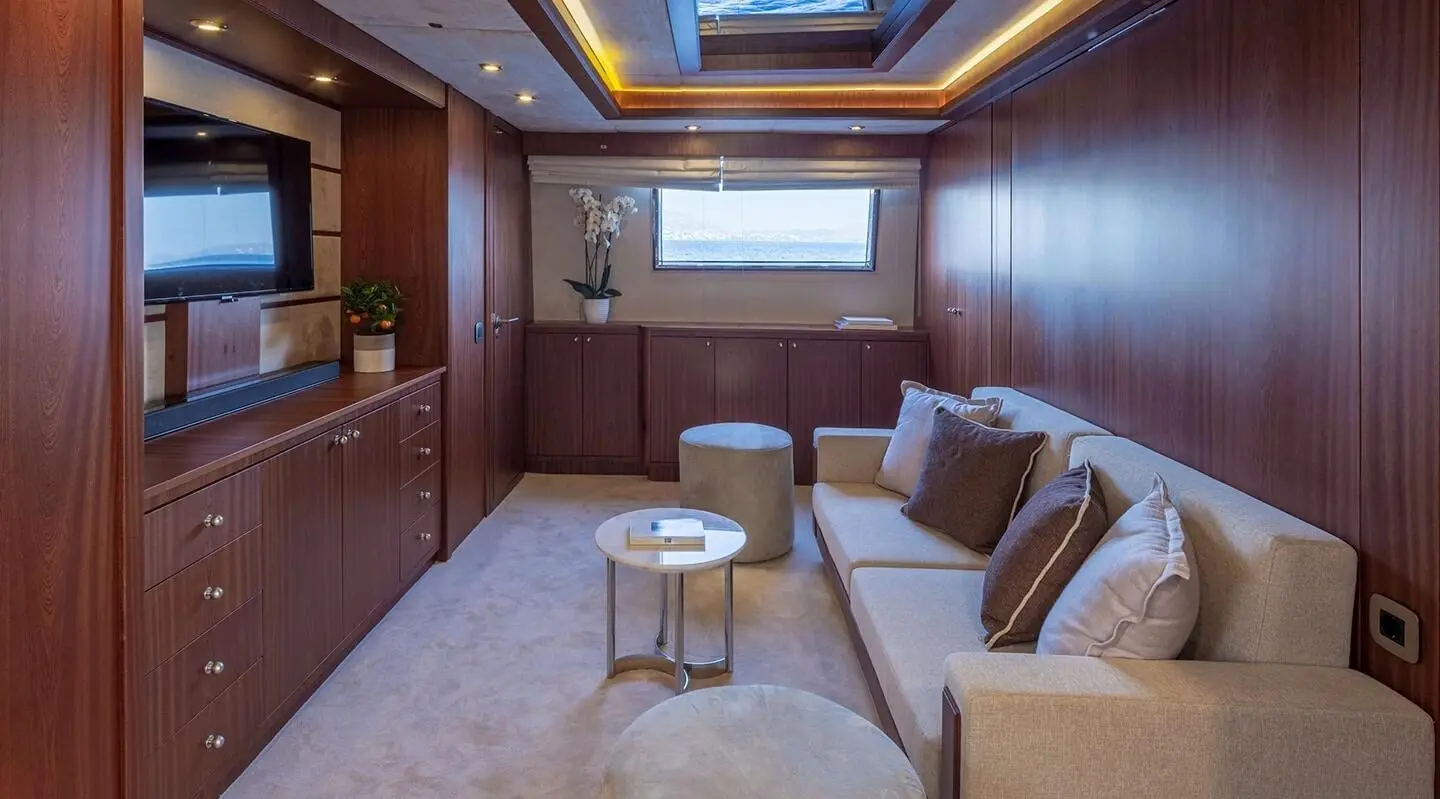 Interior yacht Grace lounge with sofa seating, coffee tables, and ambient lighting