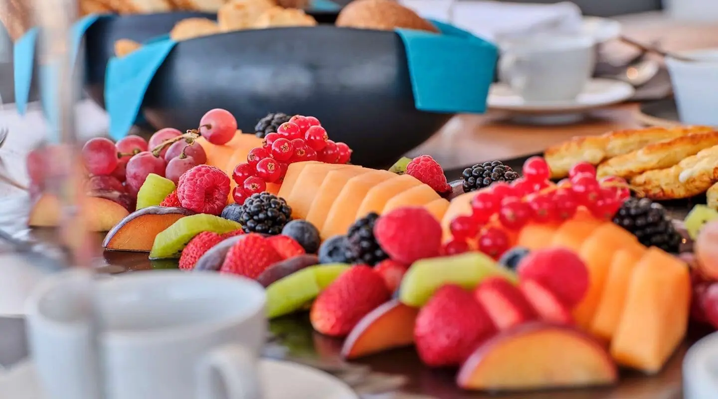 Christal Mio yacht with a table of fresh fruit platter on deck