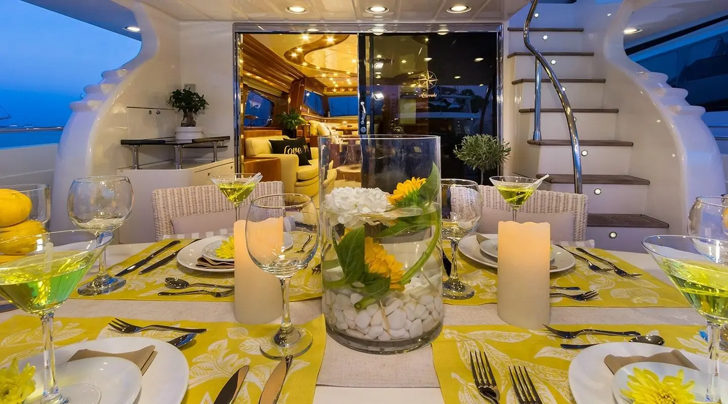 Amoraki yacht sunset deck scene with table set for dinner outdoors
