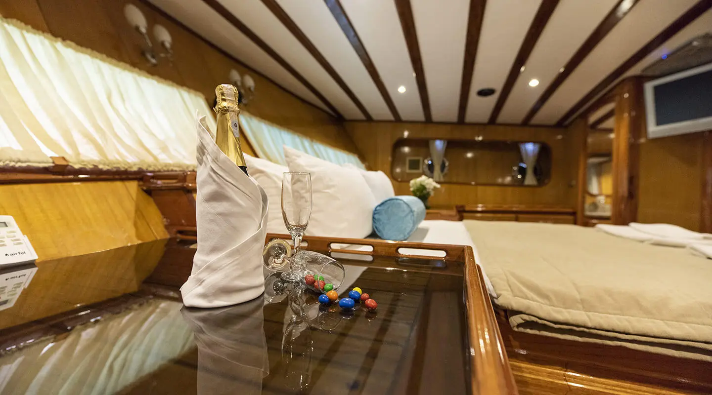 Luxurious Kayhan 5 yacht interior at sunset with guests on deck