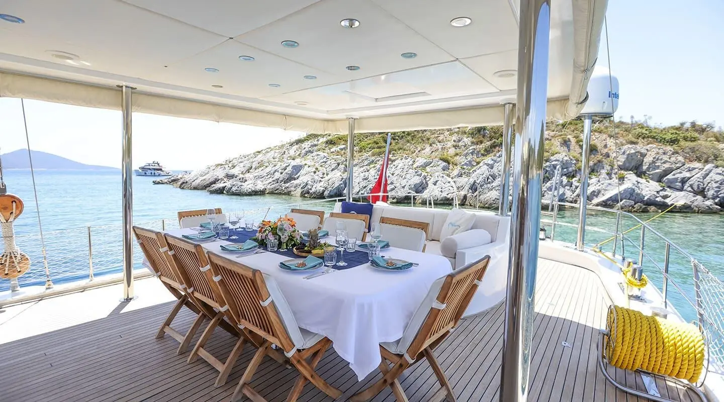 Gazella yacht charter on a sunset gulet with a shaded deck and dining setup