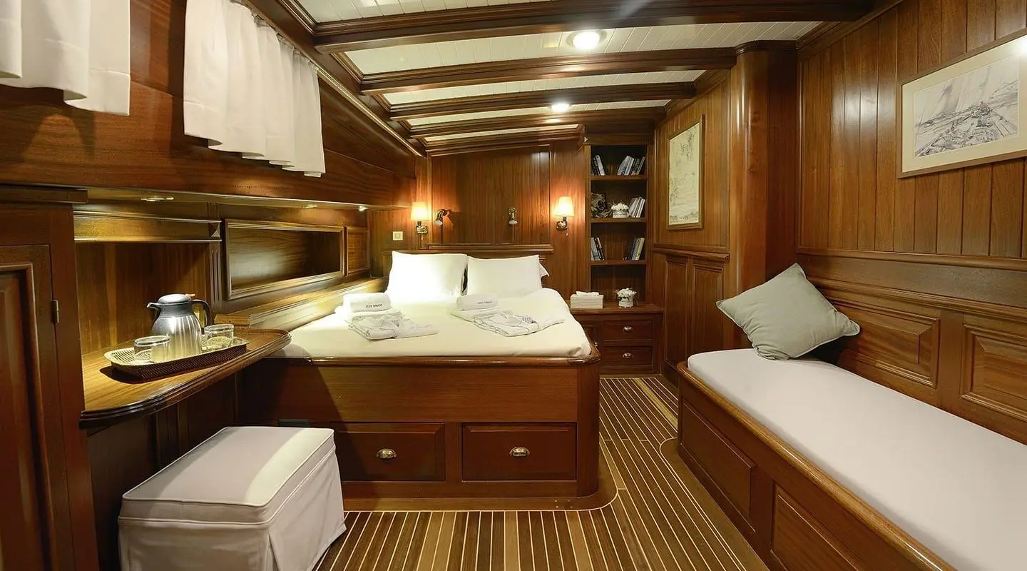 Luxurious yacht Ecce Navigo interior with wooden cabinetry and warm lighting
