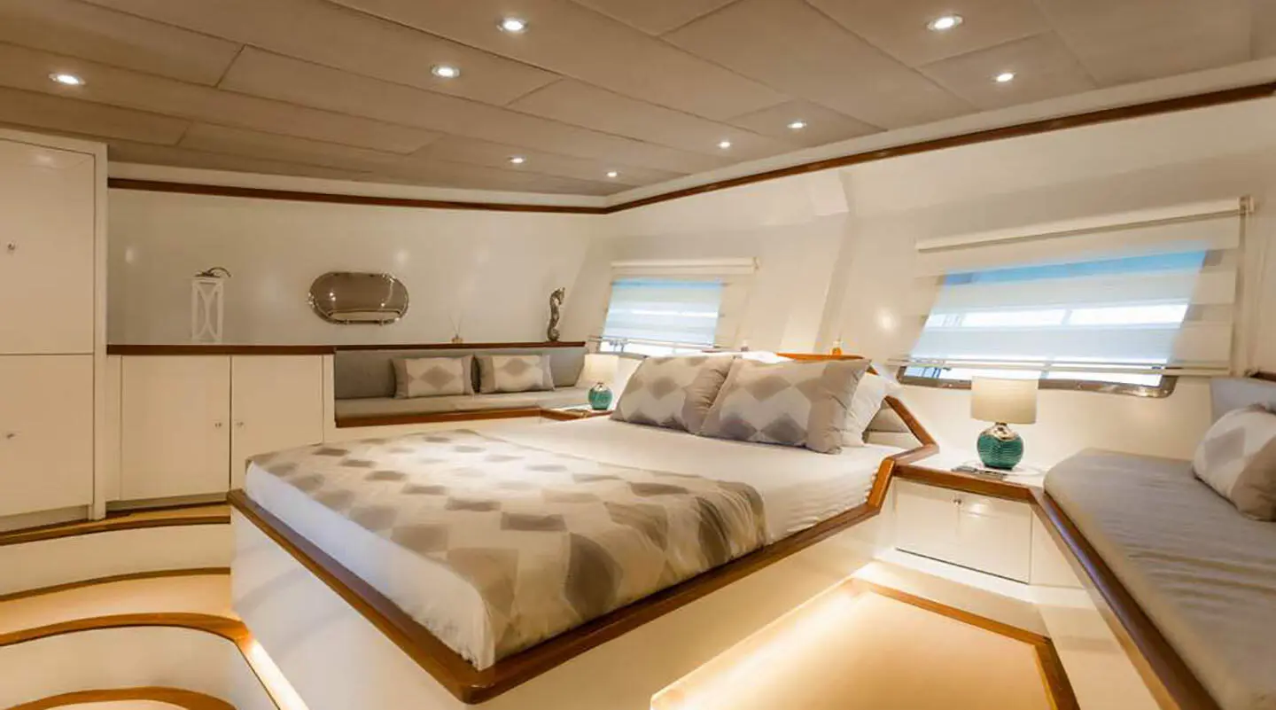 Gulet Grand Sailor master cabin with large bed and wooden decor inside