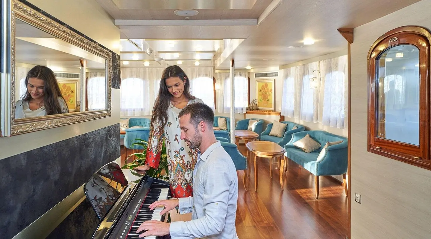 Casablanca yacht interior: passengers seated on chairs in piano lounge