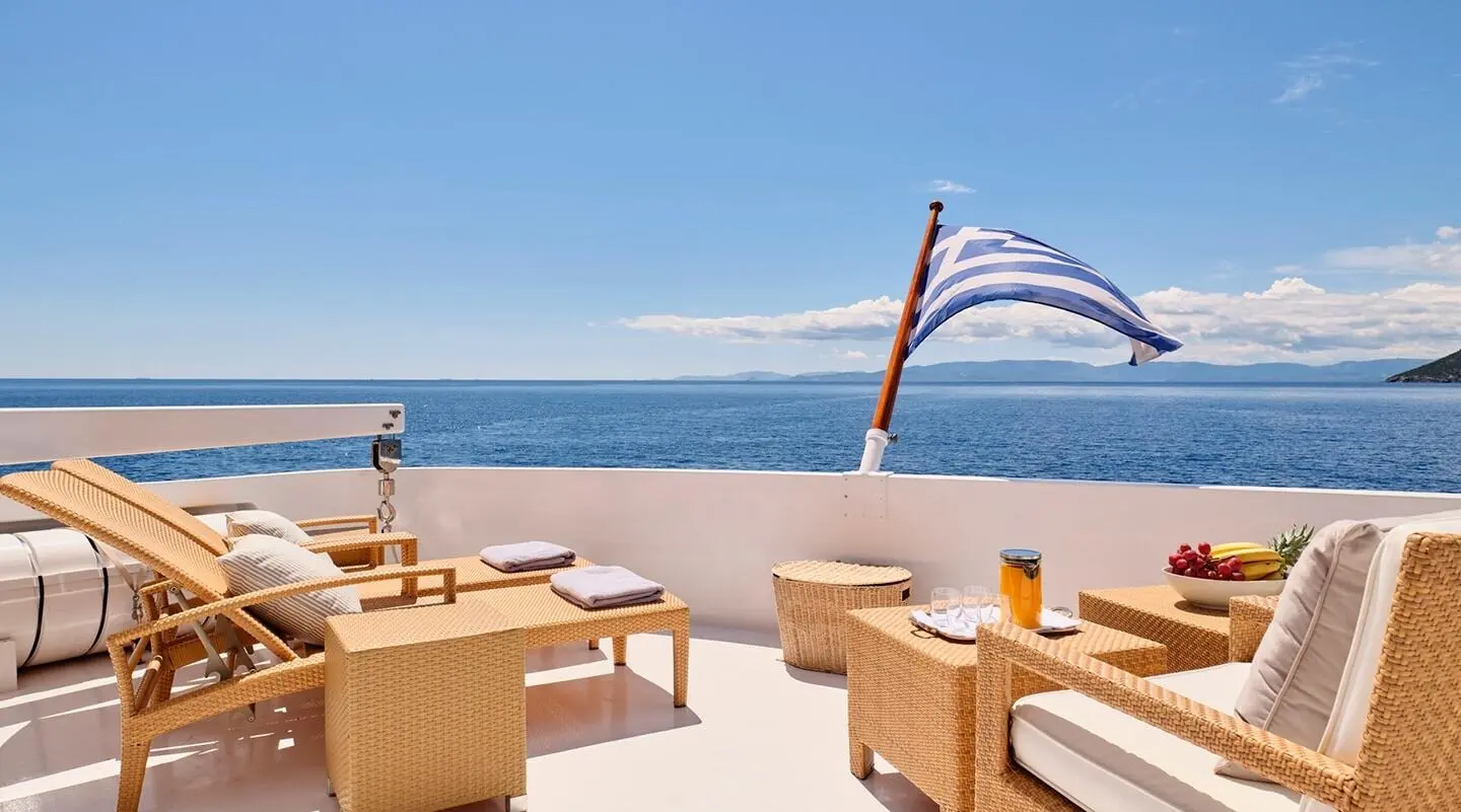 Mobius yacht deck at sunset with wicker seating and ocean view