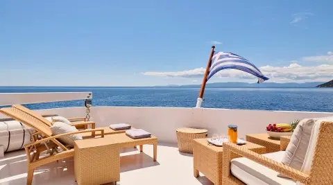 Mobius yacht deck at sunset with wicker seating and ocean view
