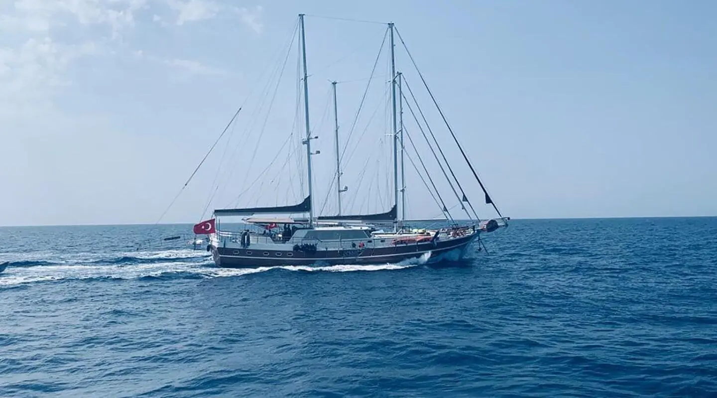 Prenses Bugce sailing yacht anchored in calm blue sea at sunset