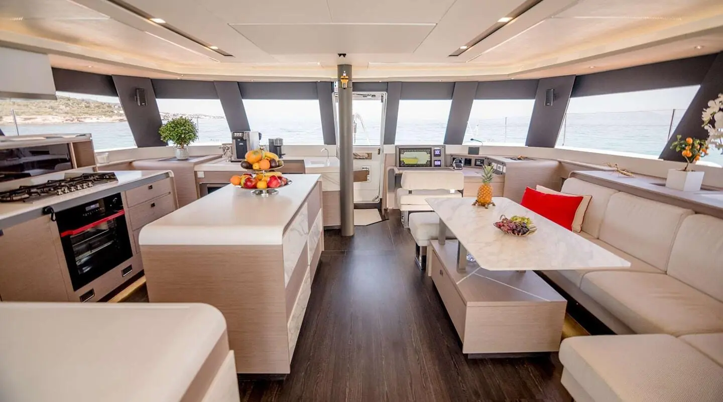 Astoria motor yacht saloon interior with white seating, wooden floor, and windows