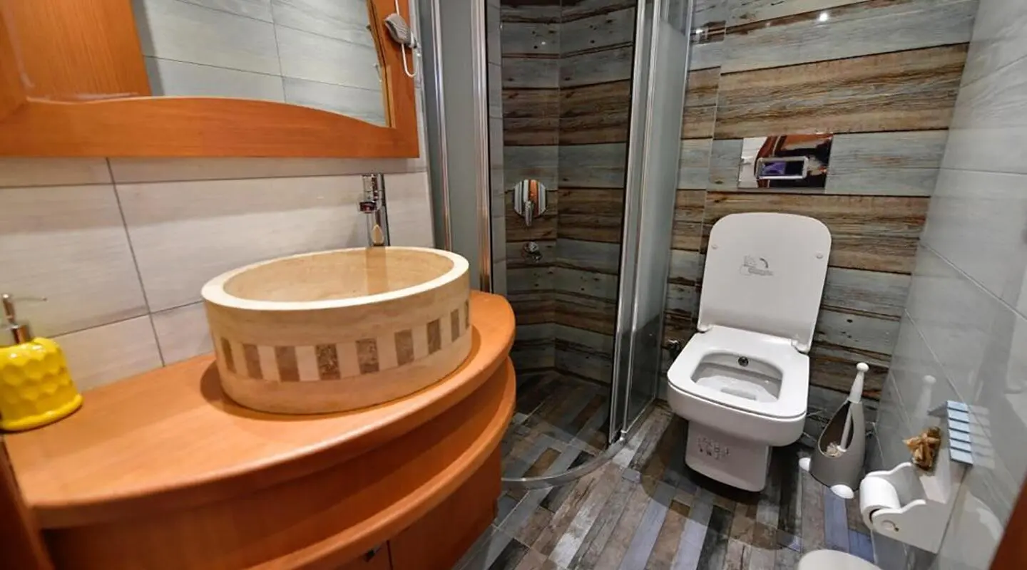 Blu Dream gulet bathroom area with wooden tub and shower enclosure on deck