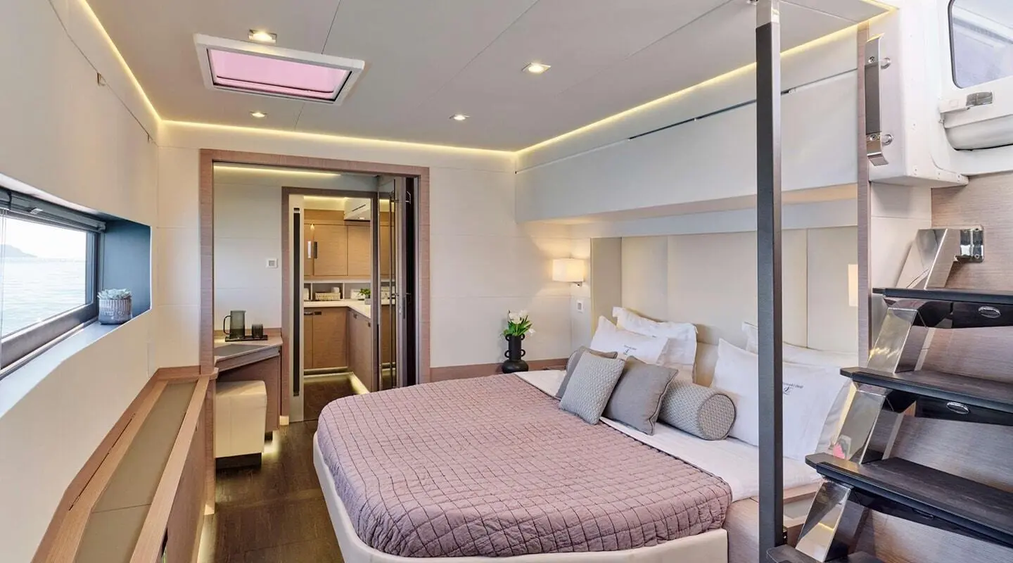 Christal Mio motor yacht interior with a queen bed and bedside lamps