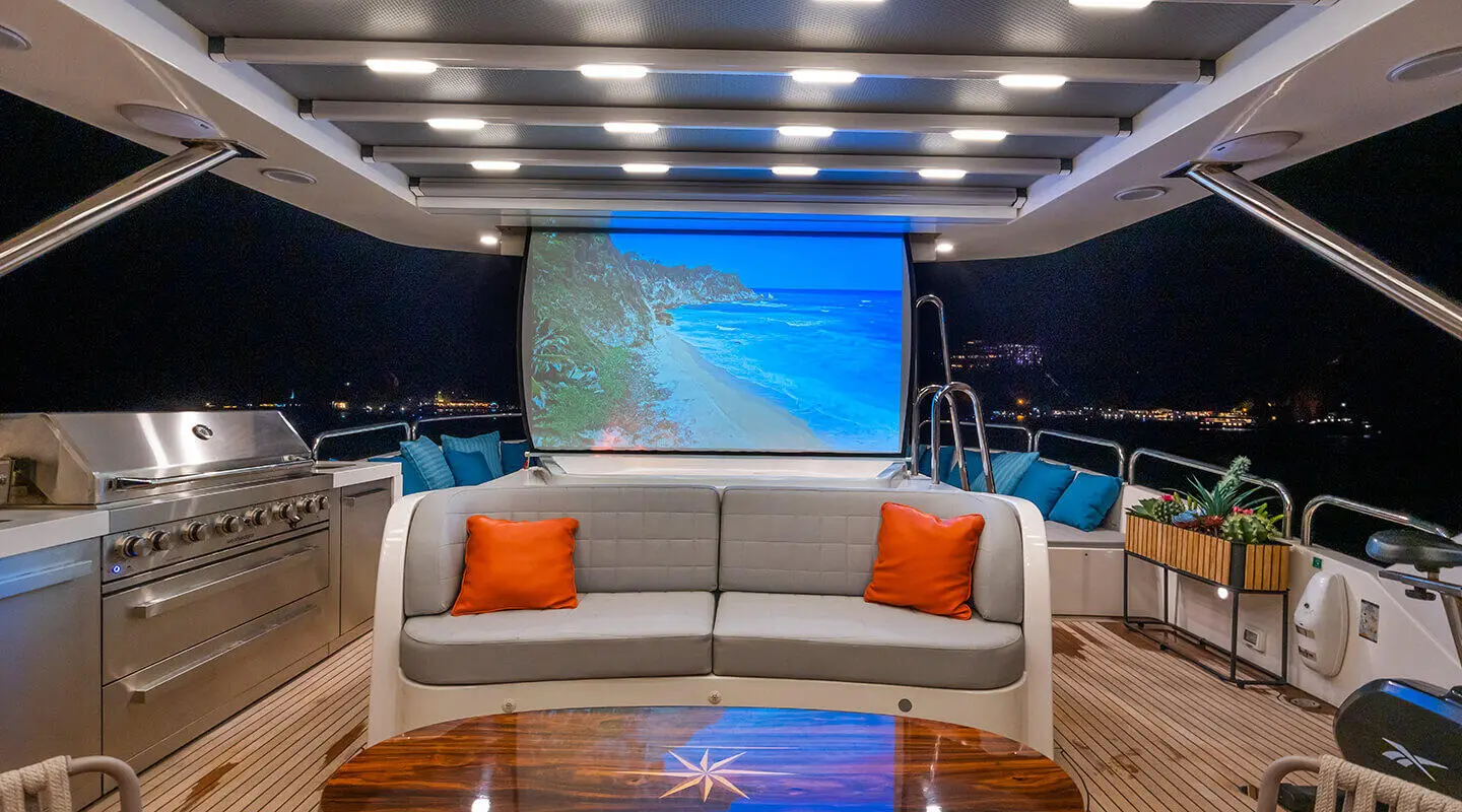 Amadea yacht's outdoor aft with seating area at night