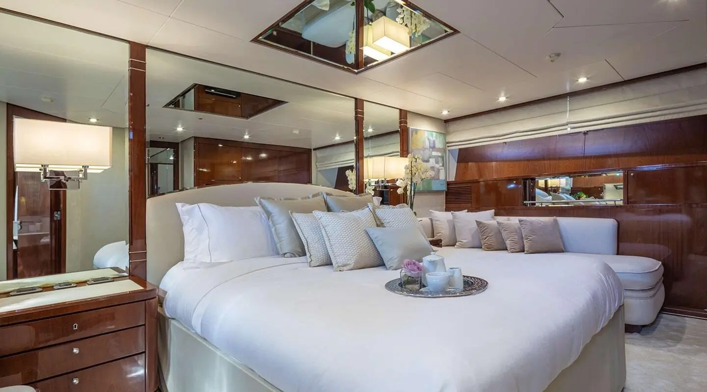 Grace yacht’s luxurious master cabin with plush white bedding and mirrors