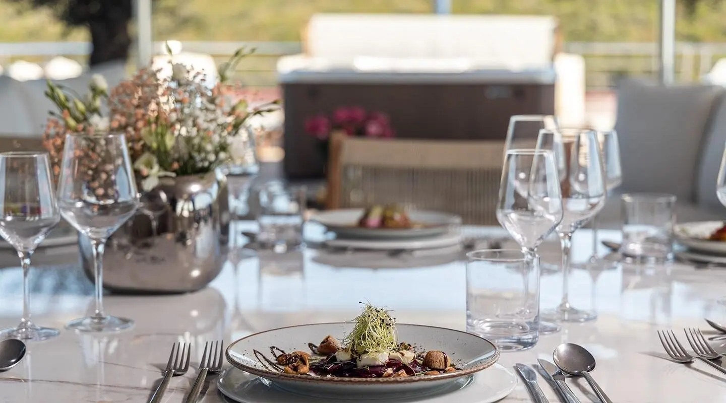 Olimp yacht dining on deck with plated dish and glassware
