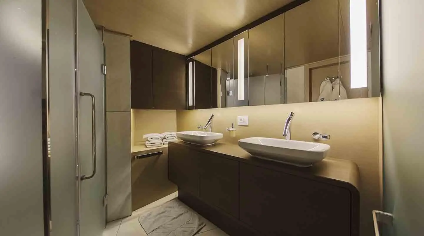 Omnia motor yacht bathroom with dark wood cabinets and white sink area