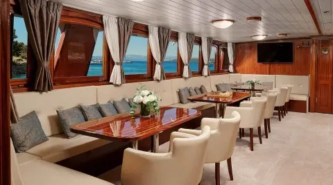 Luxurious yacht Luna salon interior with cream seating and wooden accents