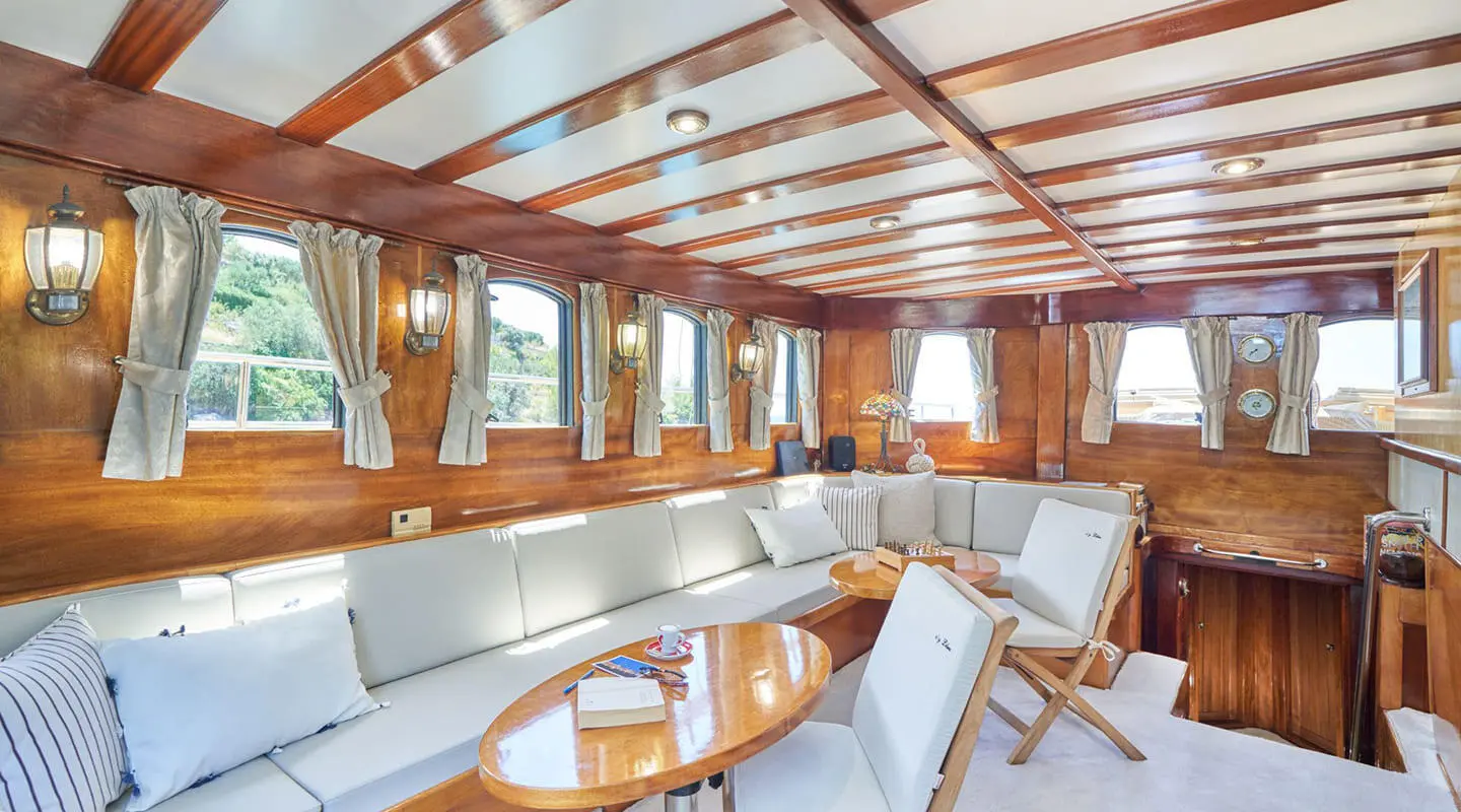 Luxurious yacht Libra salon interior with wooden beams and seating
