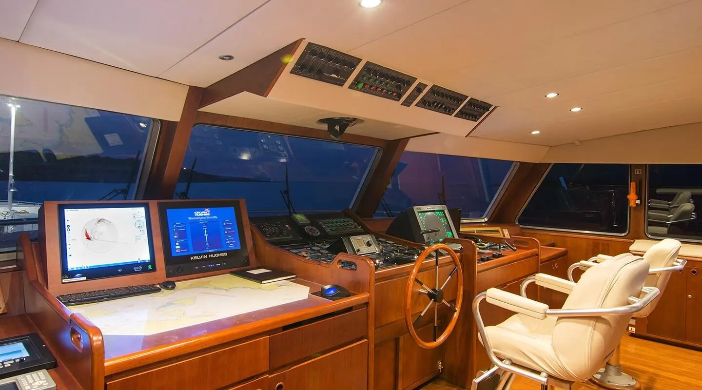 O'Natalina yacht wheelhouse interior with navigation screens and wooden panels