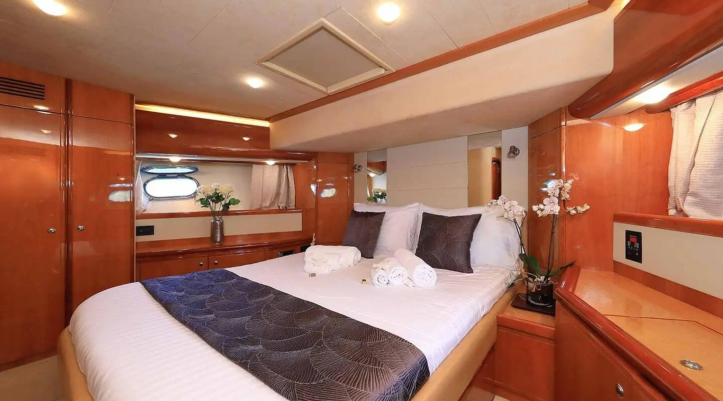 Quo Vadis I luxury yacht deck at sunset with twin beds and warm wood interior
