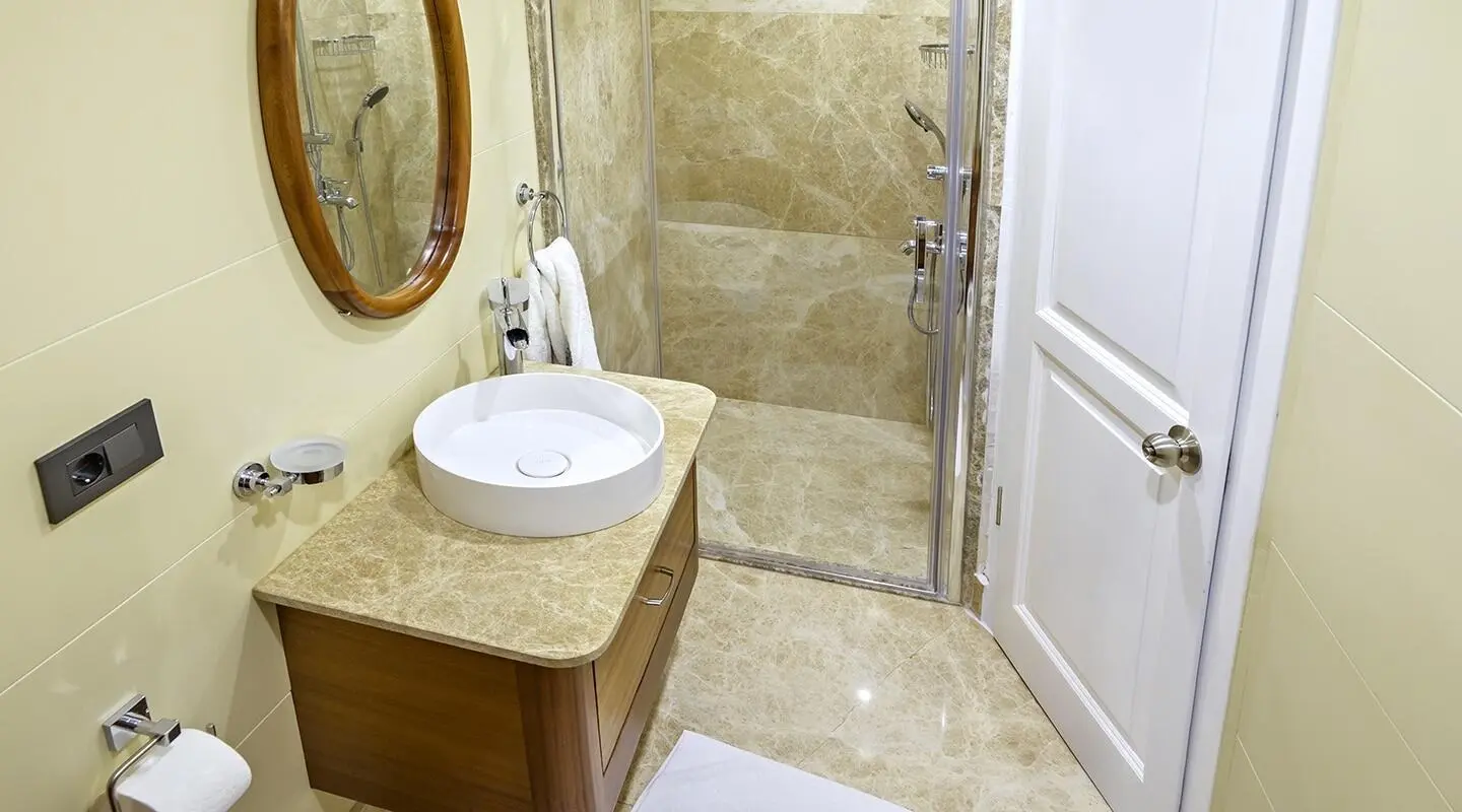 Bella Mare yacht bathroom with marble vanity, vessel sink, wooden cabinet