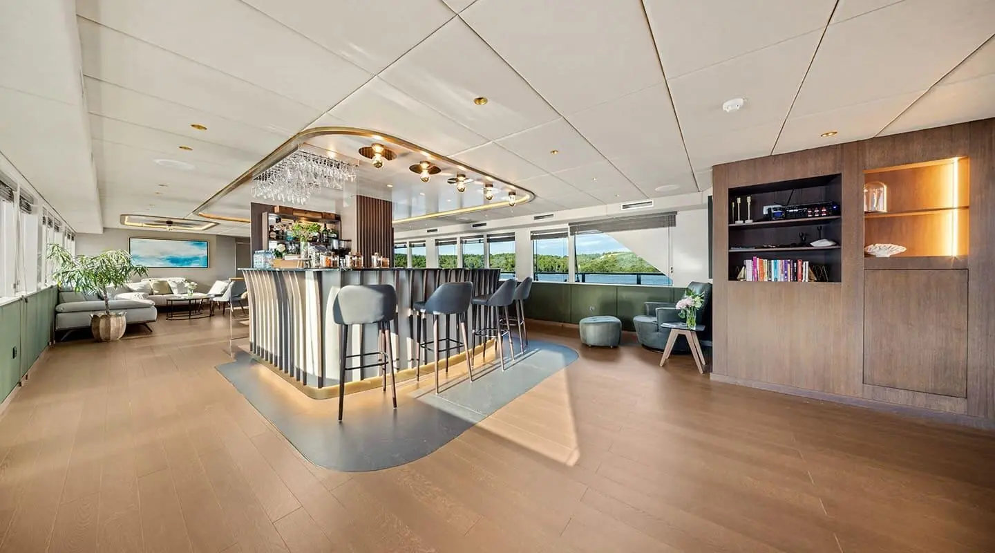 Anima Maris yacht interior bar area with modern seating and warm lighting