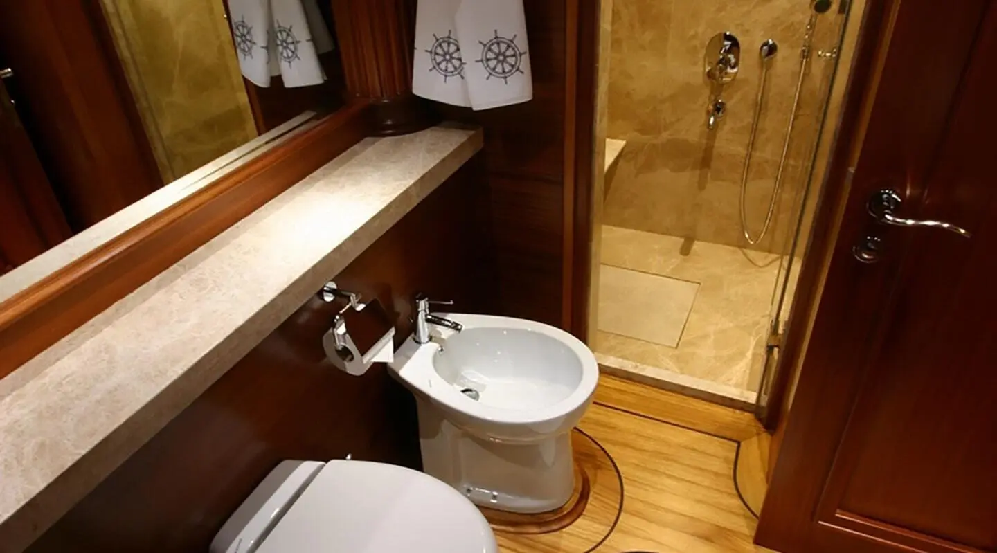 Kaya Guneri 5 yacht interior with wooden panels and a small white sink