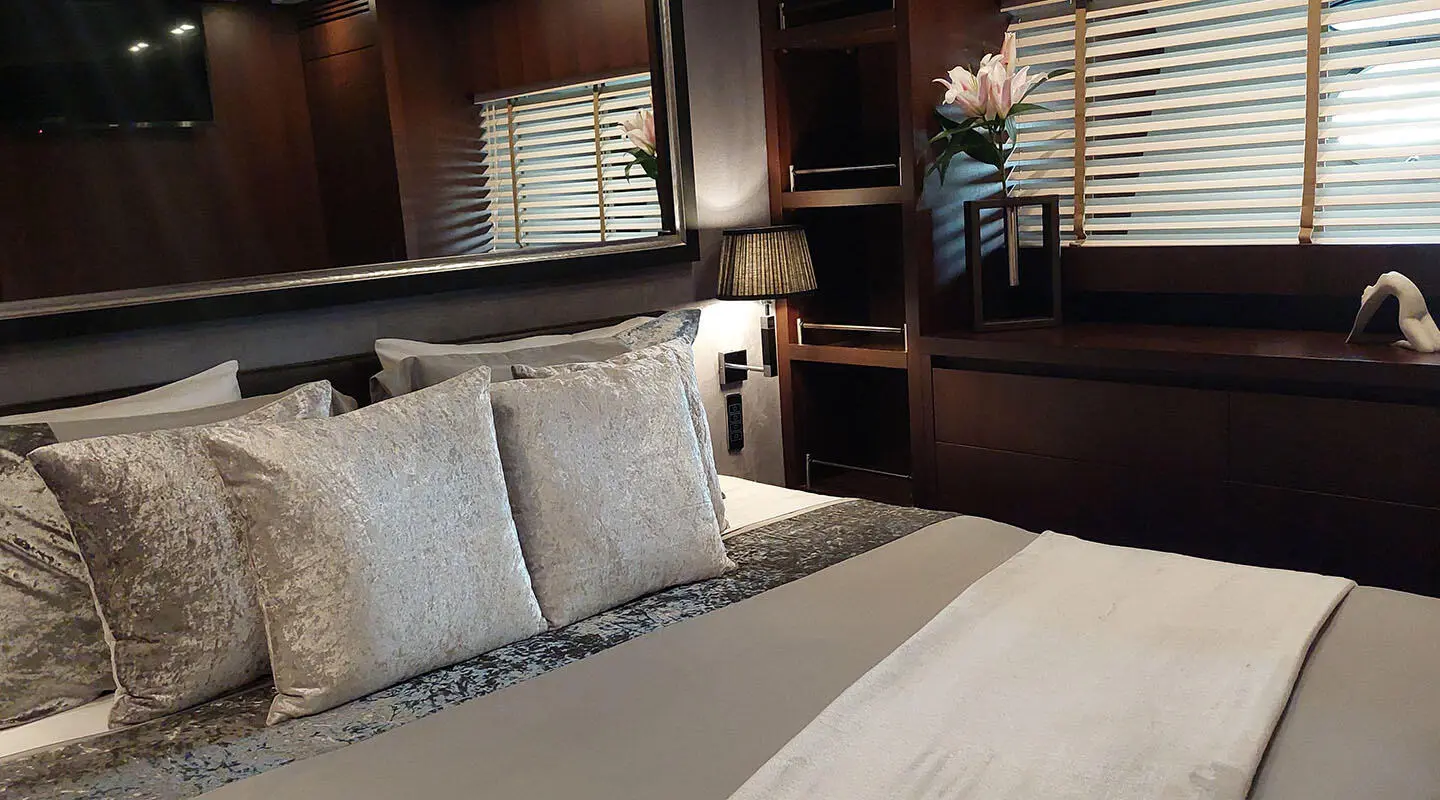 Luxurious yacht Miraval bedroom with bed and wood paneling interior