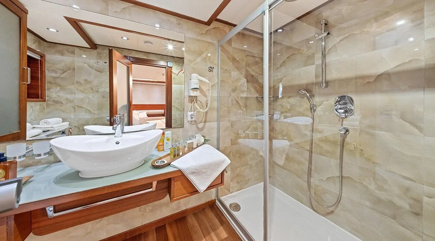 Gulet Alessandro I double suite bathroom with wooden vanity and glass shower