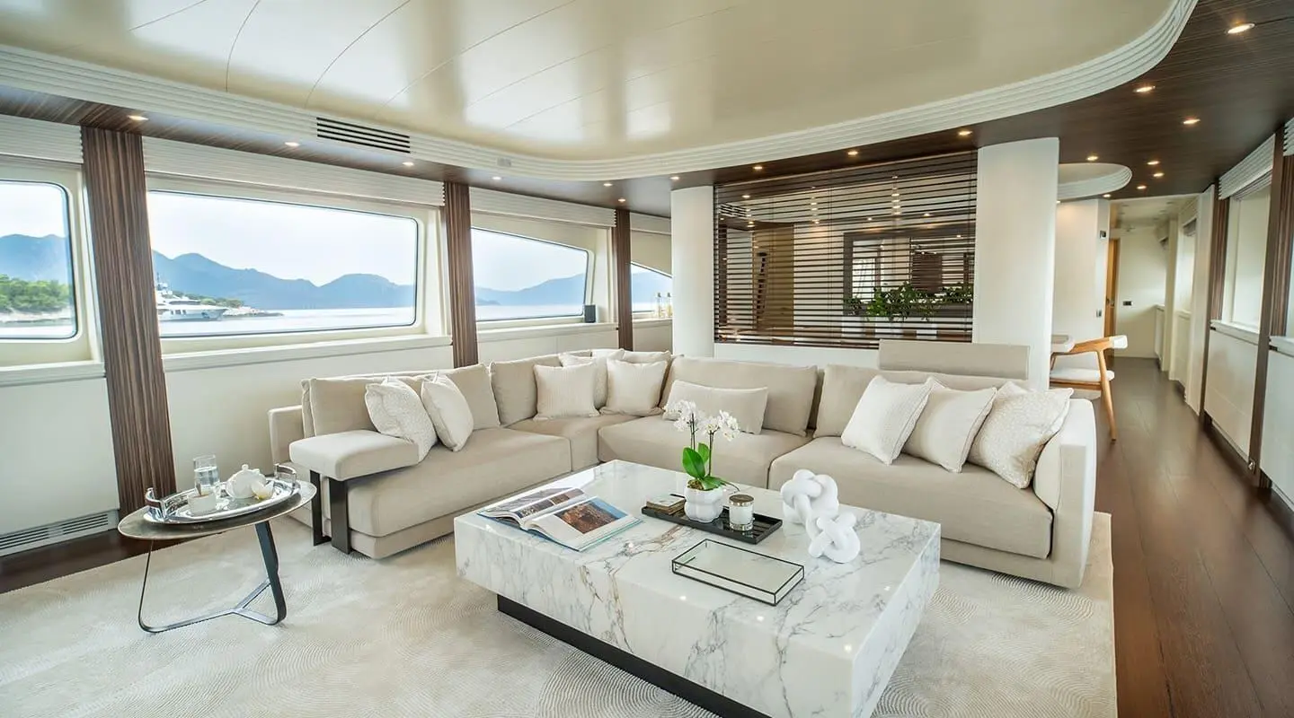 Inside lounge of Pareaki II with light beige sofas and marble coffee table