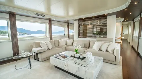 Inside lounge of Pareaki II with light beige sofas and marble coffee table