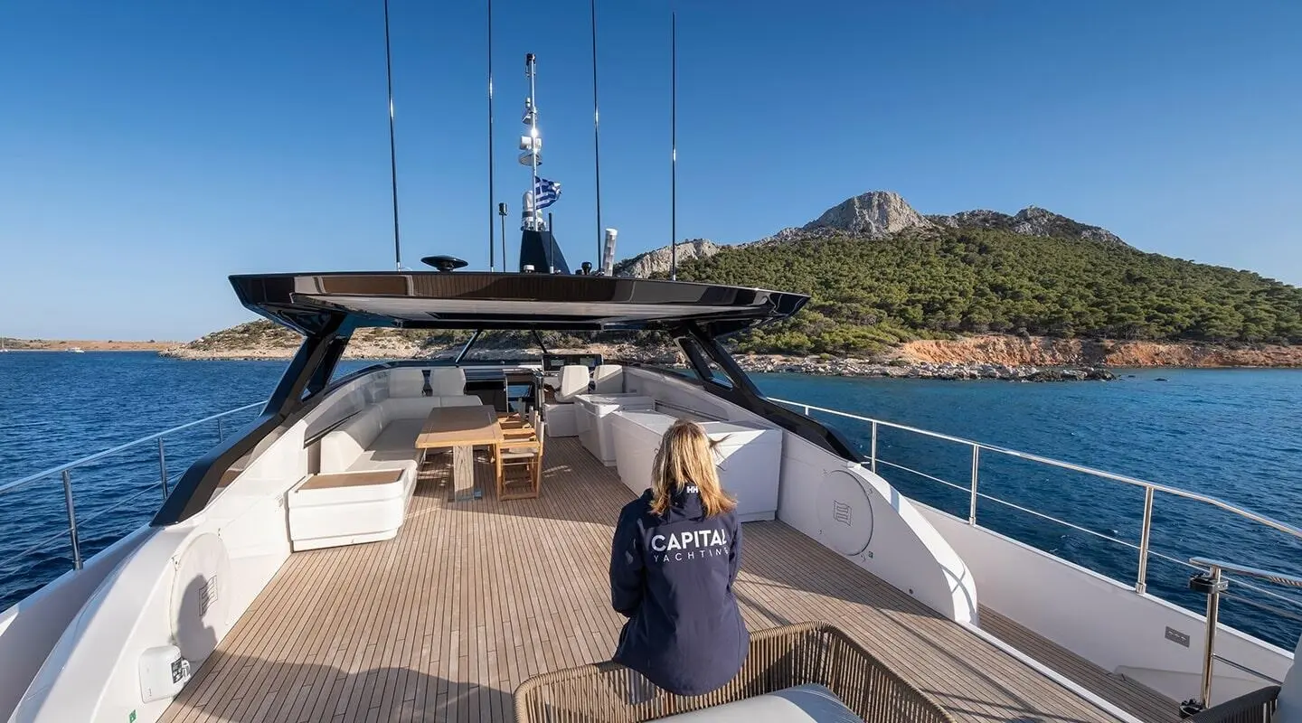 Spica yacht deck on calm sea with seating and clear blue sky