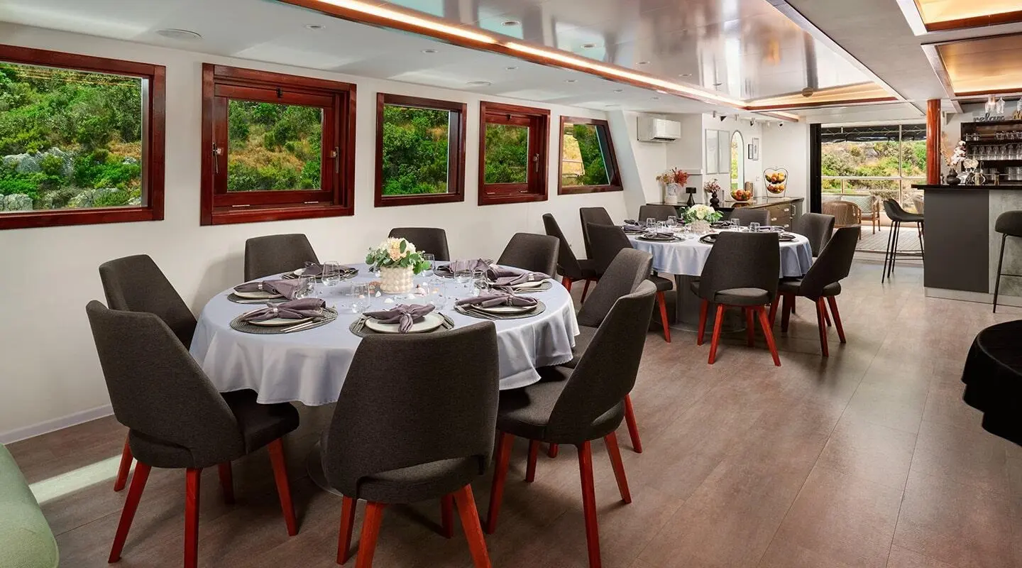 Lupus Mare luxury yacht dining area at sunset with table settings